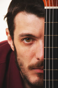 Close-up portrait of young man with guitar