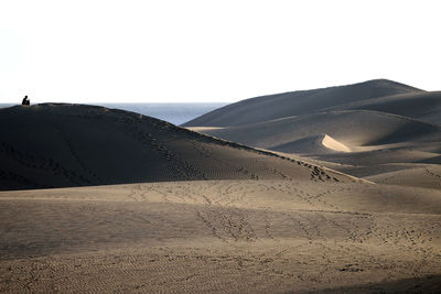 Scenic view of desert against clear sky