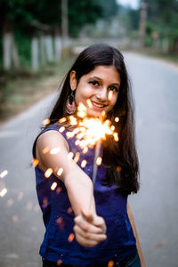 Portrait of smiling young woman standing outdoors