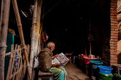 Rear view of man working in building