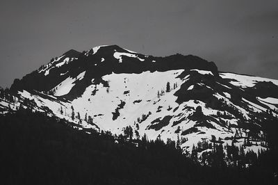 Low angle view of snowcapped mountains against clear sky