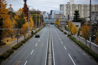 Vehicles on road along buildings