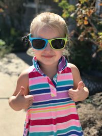 Portrait of boy wearing sunglasses standing outdoors