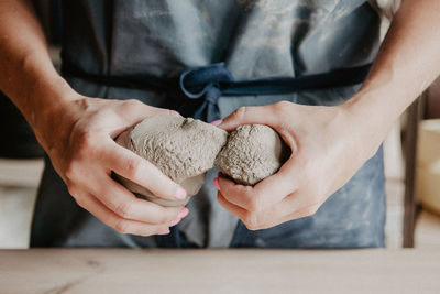 Midsection of woman at pottery workshop