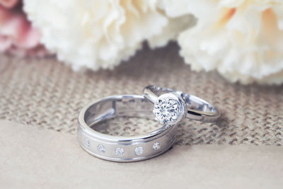 Close-up of wedding rings on table