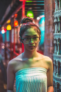 Portrait of teenage girl wearing eyeglasses at night