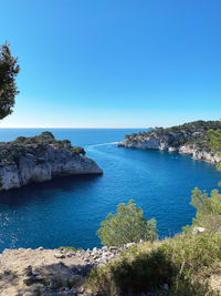 Scenic view of sea against clear blue sky