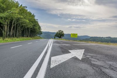 Road sign against sky