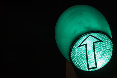 Close-up of illuminated lighting equipment against black background