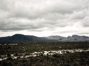 View of landscape against cloudy sky