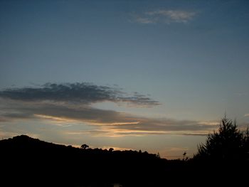 Silhouette of landscape against sky at sunset