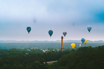 Hot air balloons flying against sky