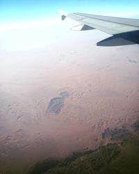 Cropped image of airplane flying over landscape