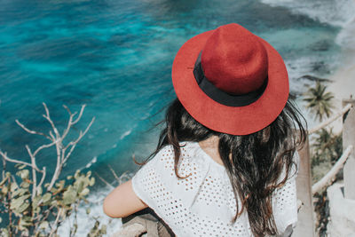 Rear view of woman wearing hat at beach