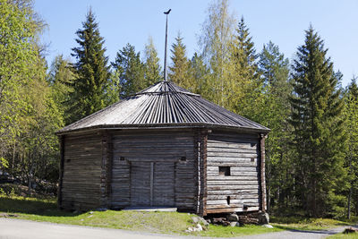 Built structure on field against trees