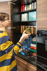 Side view of young man working at home