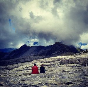 Scenic view of mountains against cloudy sky