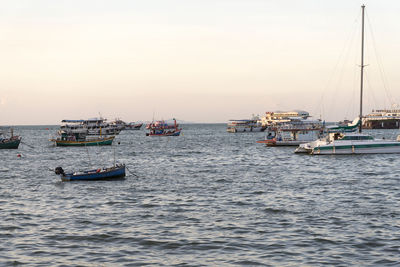 View of boats in sea at sunset