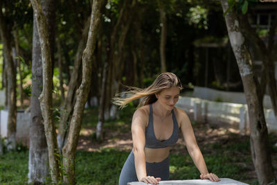 Portrait of young woman sitting in park