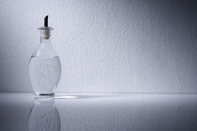 Close-up of water bottle against wall