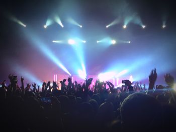 People enjoying music concert at night