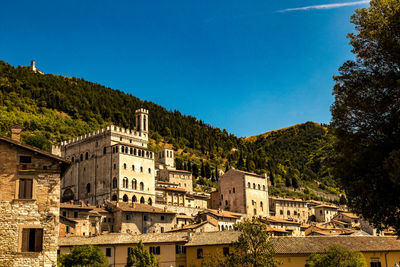 Low angle view of buildings against blue sky