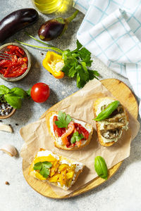 Open sandwiches set with salted salmon, sun dried tomato, grill aubergine, grill bulgarian pepper. 