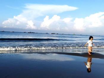 Man on beach against sky