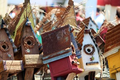 Close-up of rusty birdhouses at market stall