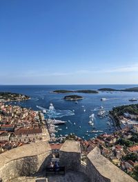 High angle view of townscape by sea against sky