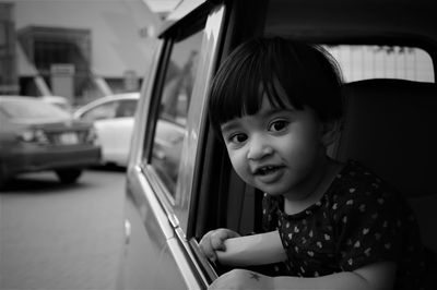 Portrait of cute girl in car