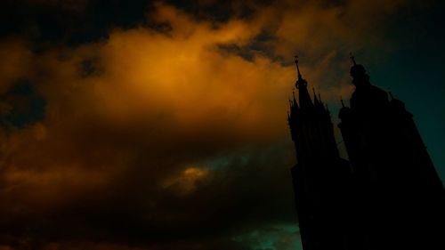 Low angle view of building against cloudy sky