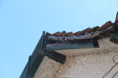 Low angle view of old building against clear blue sky