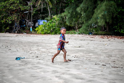 Full length of boy playing on field