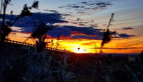 Scenic view of landscape against sky at sunset