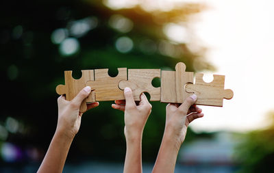 Cropped hand holding jigsaw puzzle