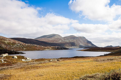 Scenic view of lake against cloudy sky