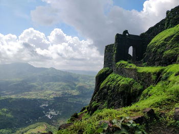 Scenic view of mountain against cloudy sky