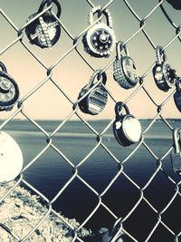 Close-up of chainlink fence against sky