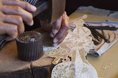 Close-up of woman doing craft on table