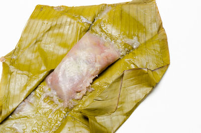 High angle view of yellow leaf on white background