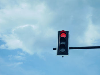 Low angle view of road sign against sky