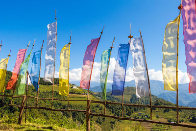 Low angle view of flags on field against sky