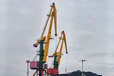 Massive harbor cranes in seaport. heavy load dockside cranes in port, cargo container ship terminal