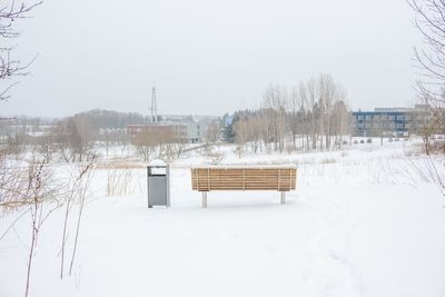 Snow covered landscape against clear sky