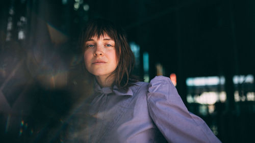 Portrait of young woman at night