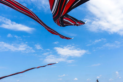 Low angle view of flags against sky