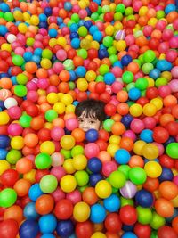 High angle portrait of boy with multi colored balls
