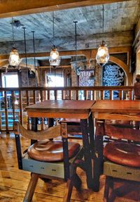 Table and chairs hanging on ceiling