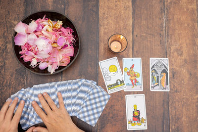 Cropped hand of woman holding food on table